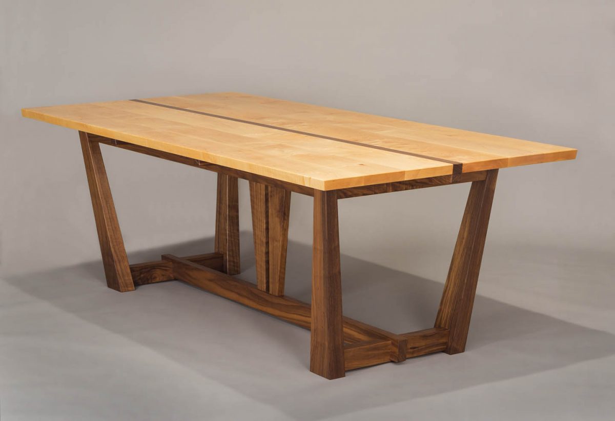 walnut and western maple dining table by Hugh Montgomery