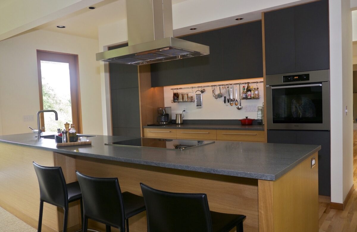 Rift white oak and plastic laminate combine to make a modern kitchen