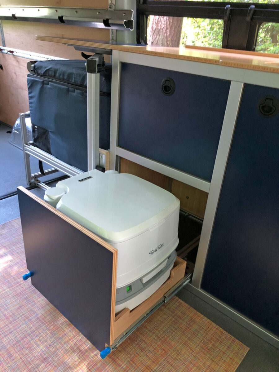 Van interior with modular galley showing pullout porta potty